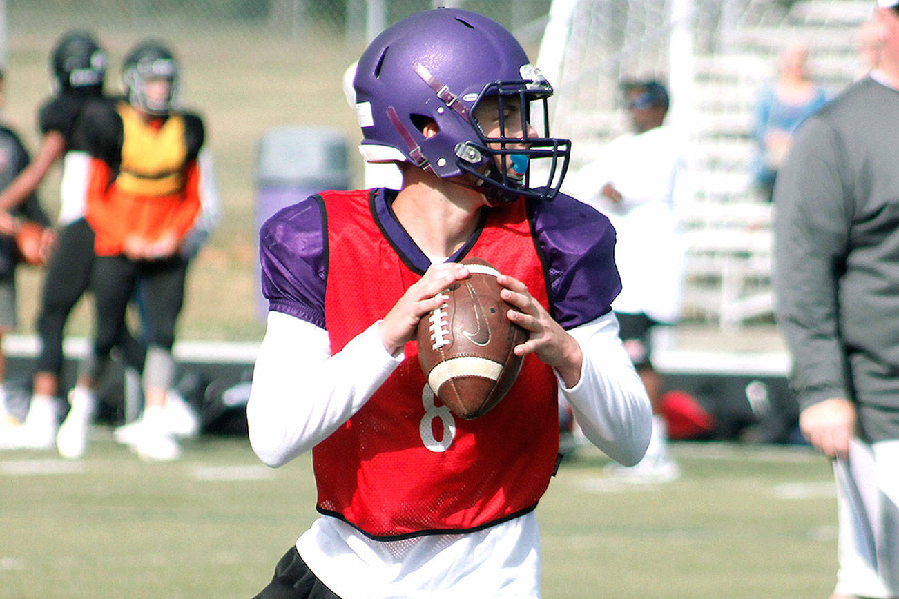 Colton Bower looks downfield for a target in Wednesday’s scrimmage against Central Kitsap. (Mark Krulish/Kitsap News Group)