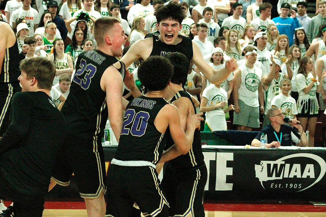 The North Kitsap boys basketball team celebrates after pulling off an improbable comeback in the semifinals in the 2A state tournament against Lynden. (File photo)