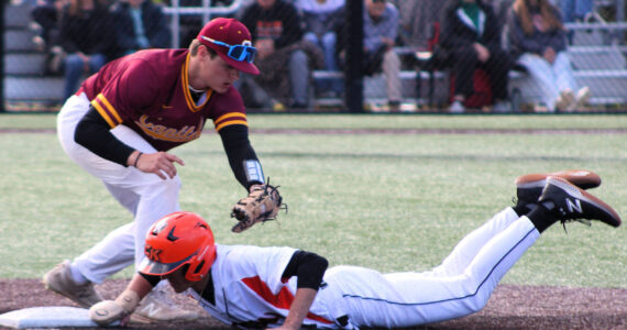 Elisha Meyer/Kitsap News Group
Tanner Herdman of Central Kitsap dives back to first base on a pickoff attempt.