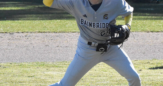 File photo
McCrea Curfman throws the ball to first base.