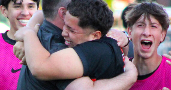 Elisha Meyer/Kitsap News Group photos
Central Kitsap soccer coach Patrick Leonard and junior Joshua Voce embrace, surrounded by cheering teammates after Voce’s game-winning shot.